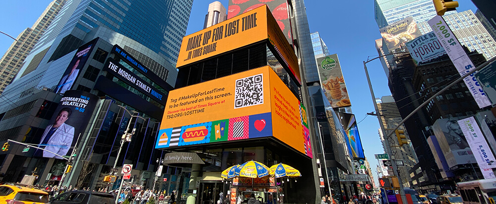 A Times Square screen displaying information about the Make Up For Lost Time campaign