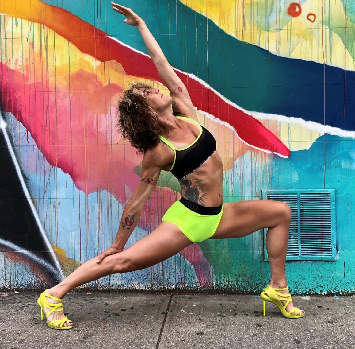 Tricia Donegan in a crescent lunge variation while wearing heels