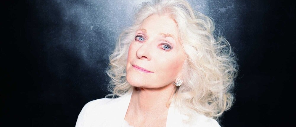 Judy Collins looks at the camera with her head tilted back
