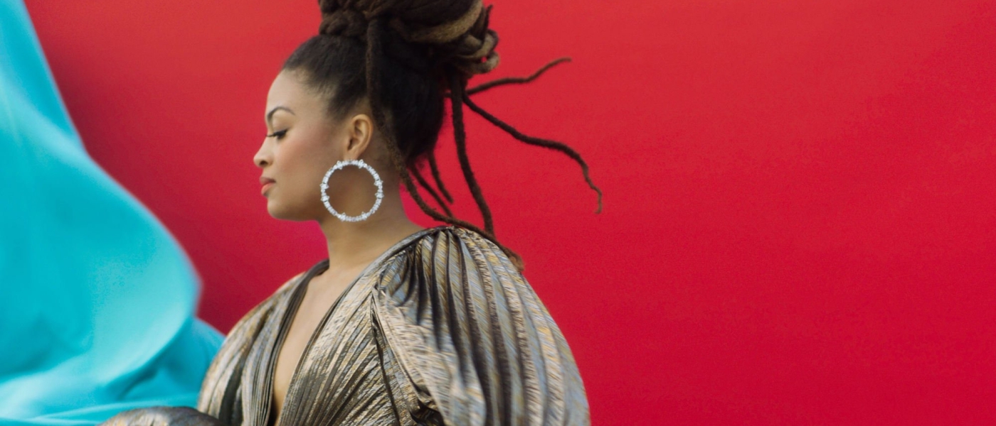 Valerie June against a red background