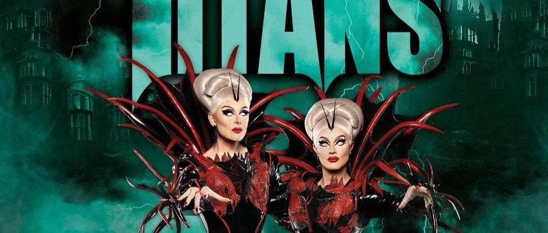 The Boulet Brothers in drag wearing elaborate dresses with large pointy black and red Medici collars that project behind their heads and their face painted to look as if their eyes are totally white. In the background is hazy images of haunted castles and lightning. Text reads: "Obsessed presents The Boulet Brothers Dragula Titans"