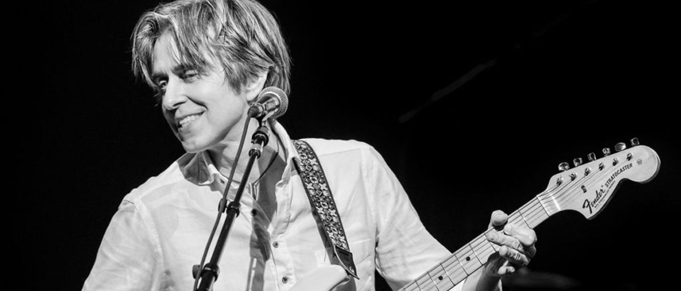 Black and white photo of Eric Johnson playing guitar
