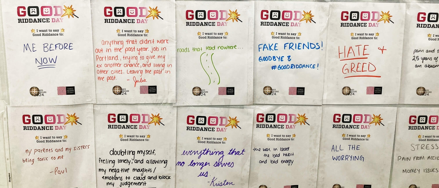 Pieces of paper with the Good Riddance Day 2023 logo featuring a magic wand. On the papers are written things that people want to say good riddance to, including negativity, hate and greed, fake friends, and all the worrying
