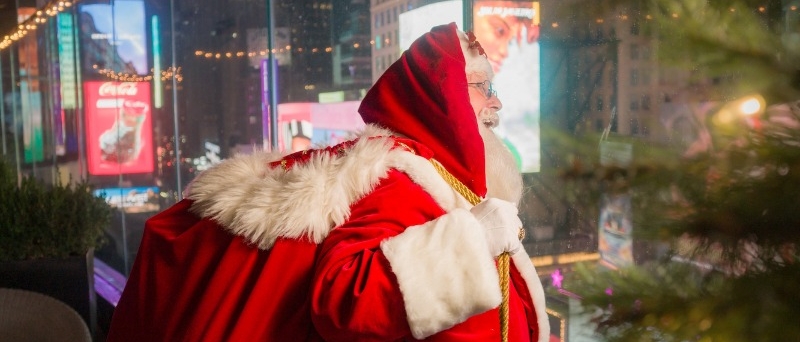 Santa standing on the outdoor terrace at the Marriott Marquis, looking out at Times Square