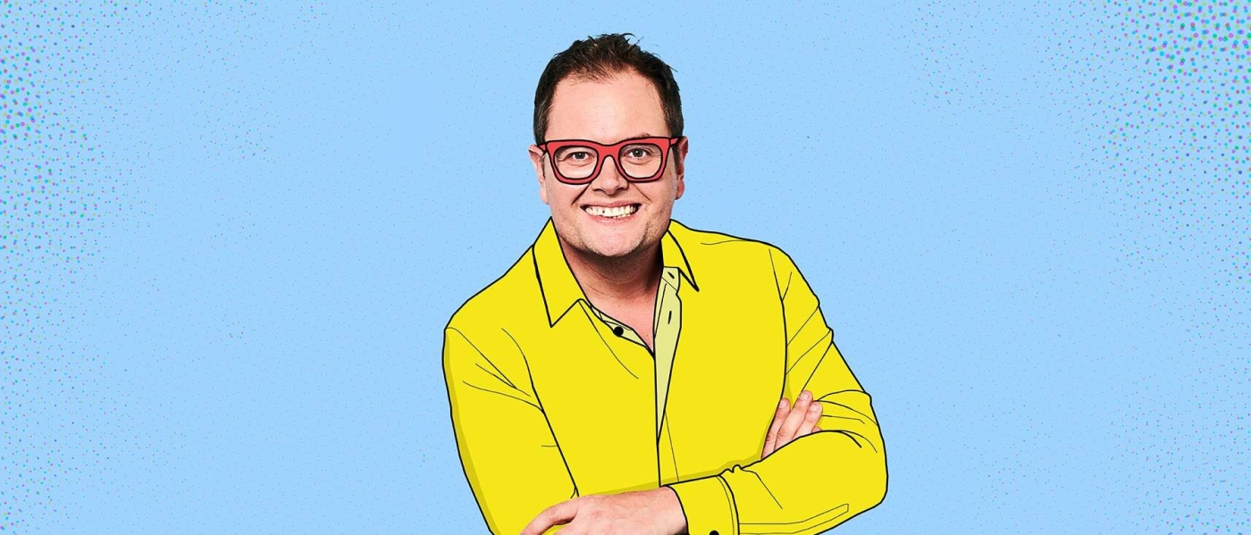 Alan Carr with an illustrated shirt and glasses