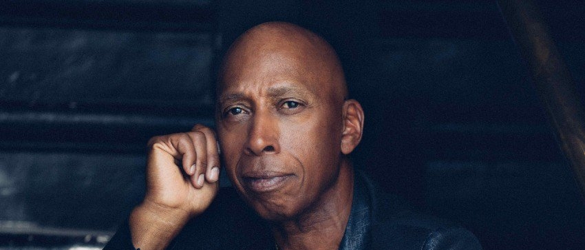 Jeffrey Osborne wearing black and looking at the camera
