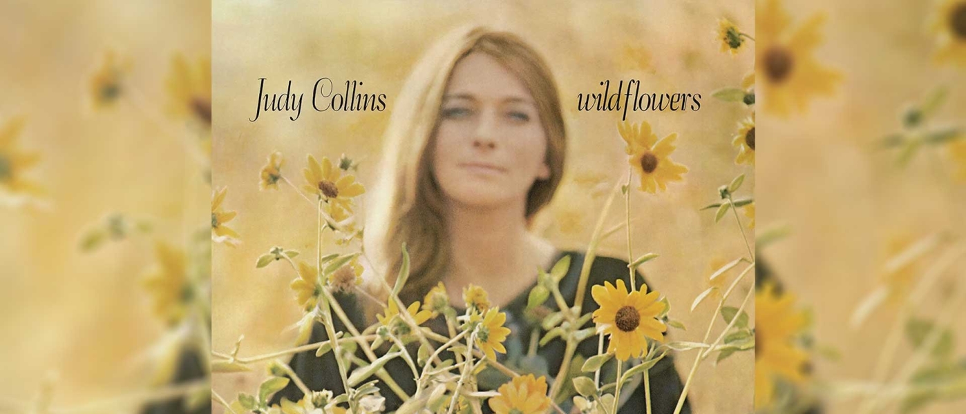 A blurry photo of a young Judy Collins in a field of flowers
