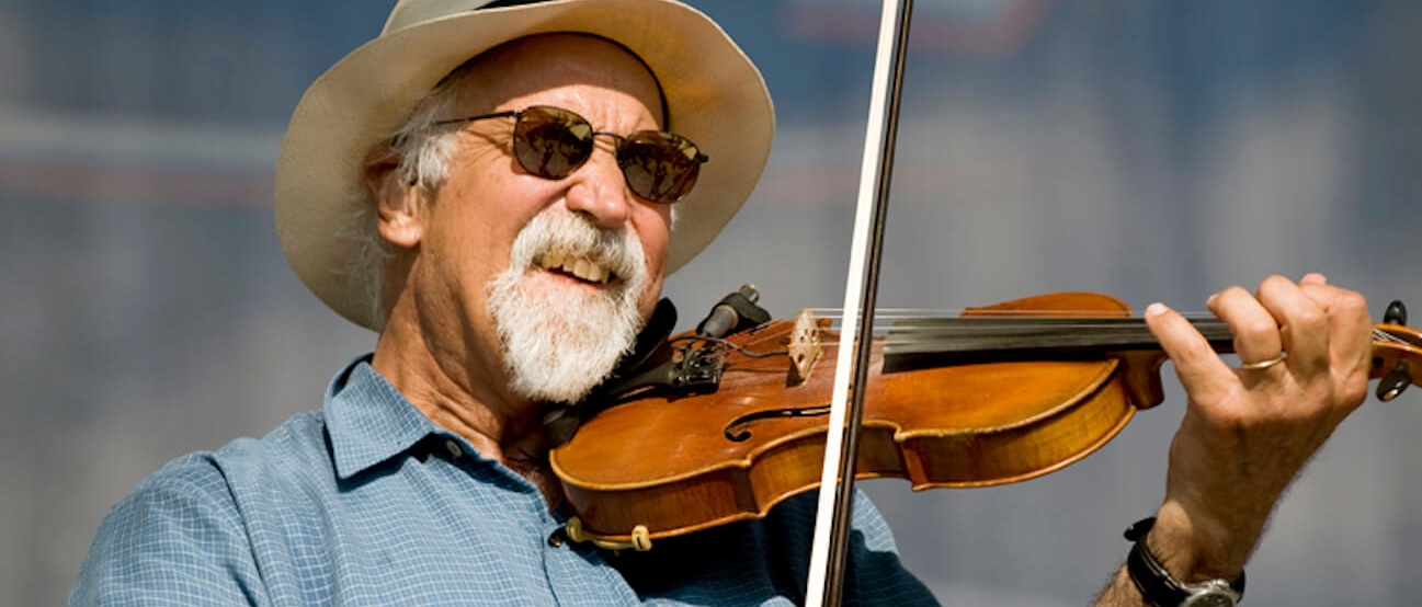 Michael Doucet, a bearded older white man, playing violin