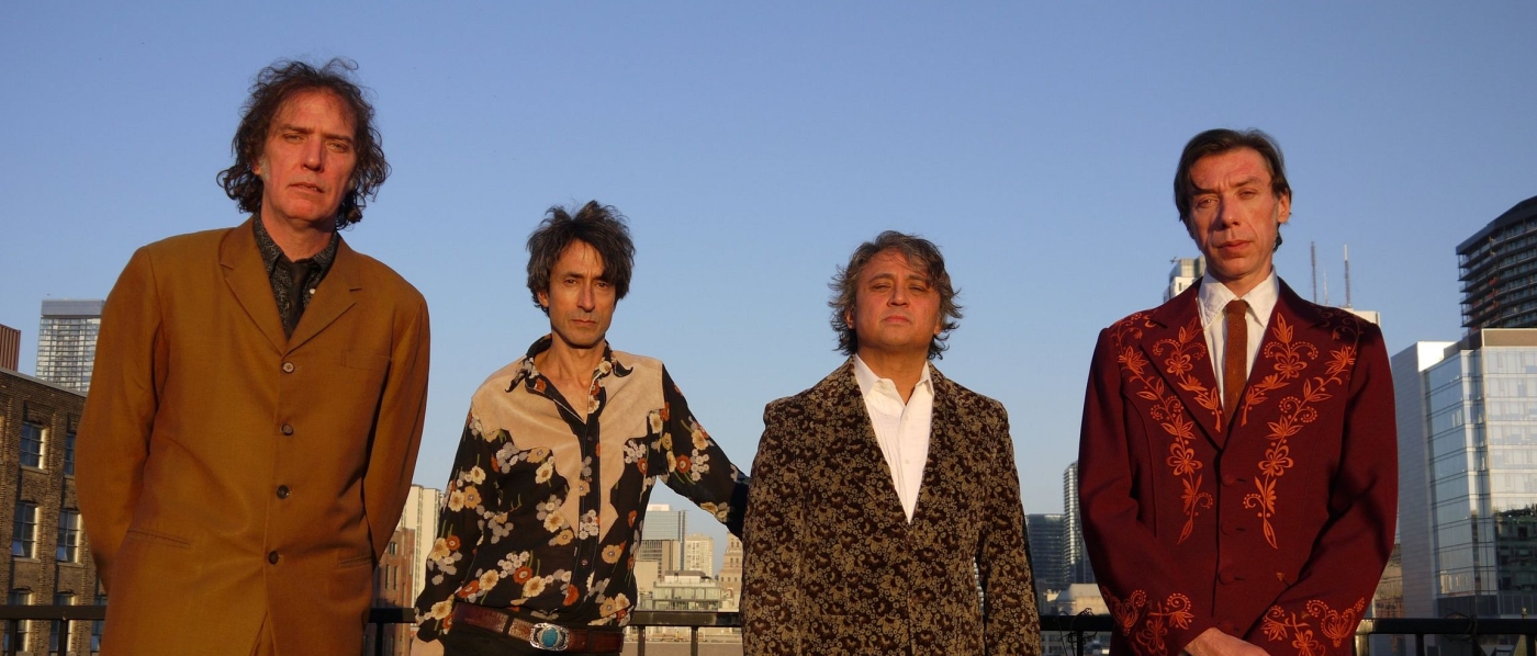The four members of The Sadies, a group of older men, standing on a rooftop