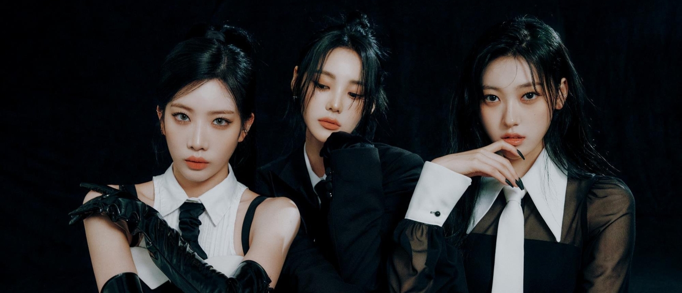 The three members of K-pop girl group Odd Eye Circle in shirts and ties