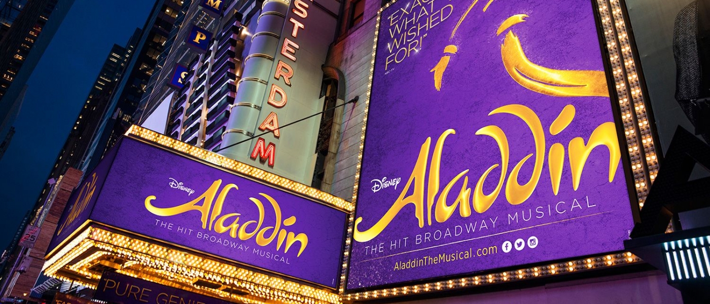 The exterior of the New Amsterdam Theatre with signs for the musical Aladdin