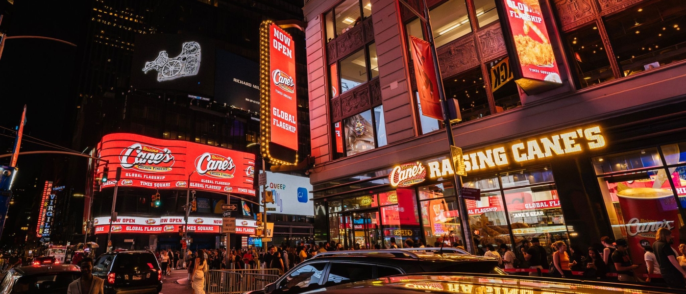 The exterior of Raising Cane's in Times Square at night
