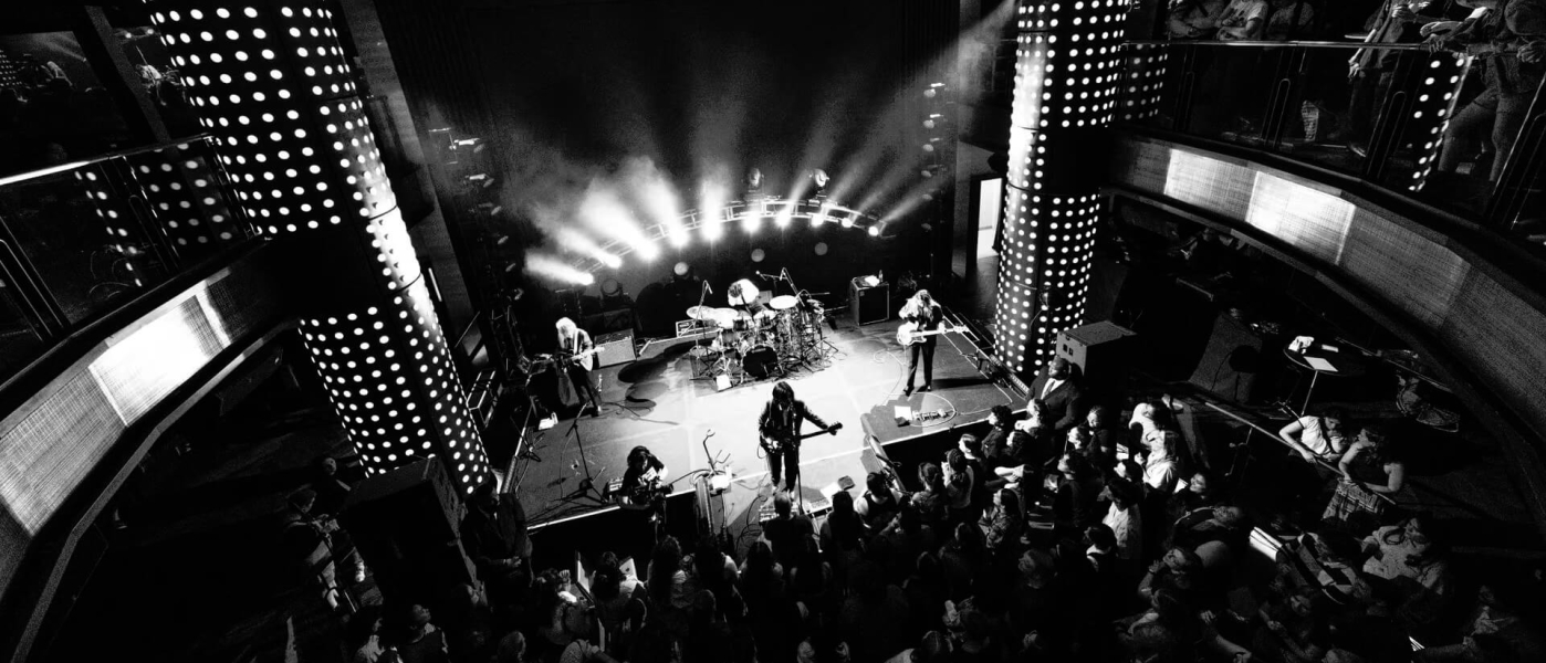 A black and white photo of a band playing at The Venue on Music Row in the Hard Rock Hotel