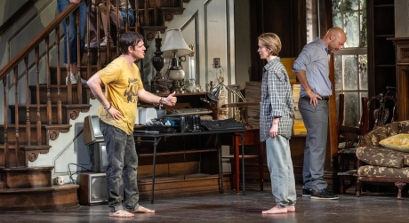 The cast of Appropriate on stage in a set made to look like a house filled with items. Two of the actors appear to be arguing with each other.