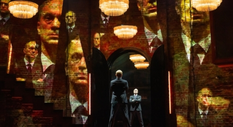 Will Keen as Putin in Patriots on Broadway, looking at himself in a mirror while projections play on the walls