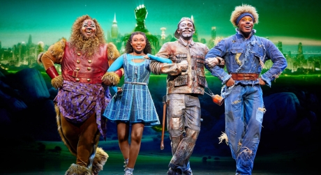 The Lion, Dorothy, Tinman, and Scarecrow linking arms on stage in The Wiz